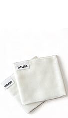 two white muslin cloths folded.