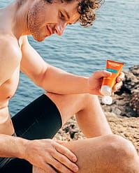 Man applying gel on legs
