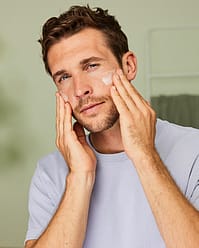Man applying face moisturiser