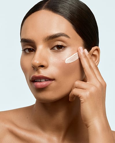 Woman holding flower near face