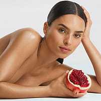 Woman holding a open pomegranate on her hand
