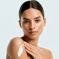 Woman with body lotion swatch on her skin