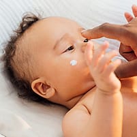 Baby with face cream