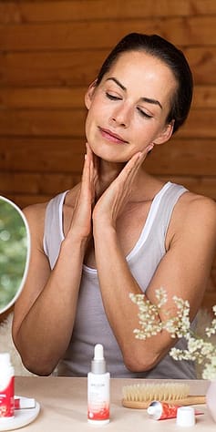 Woman tenderly applying face cream