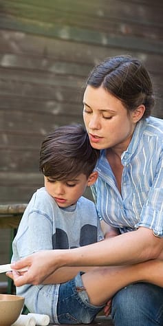 Woman tending to child's injury.