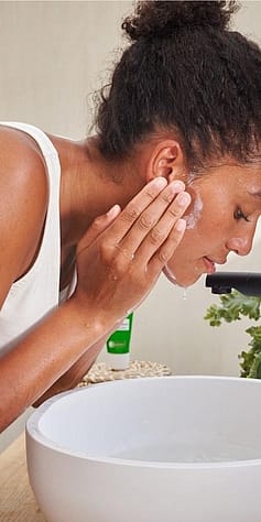 woman washing her face