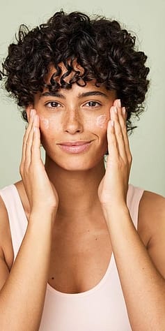 woman applying gentle milk cleanser