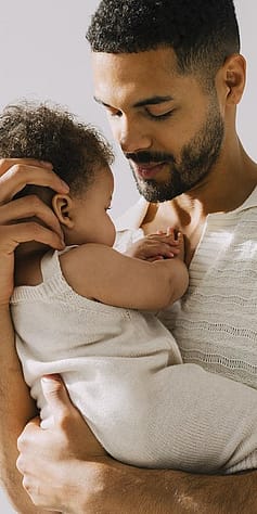 father holding baby