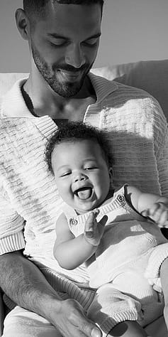 Father and baby smiling