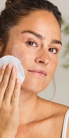 woman cleansing face