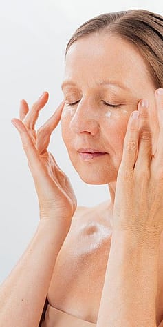 Une femme applique du sérum avec une pipette gentiane bleue