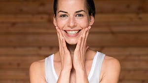 Woman touching her face