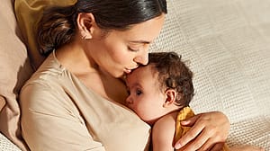 mother kissing baby