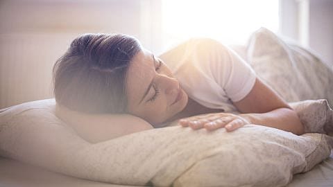 Frau schlaeft entspannt auf der Seite