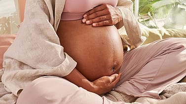 Pregnant woman holding her belly