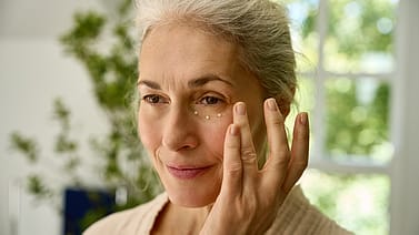 woman applying eye cream