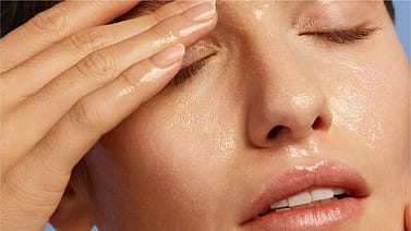Woman removing her make-up with oil cleanser
