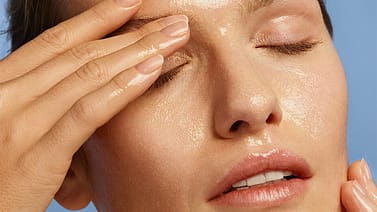 model applying makeup removing cleansing oil