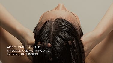 woman massaging rosmary tonic in her hair