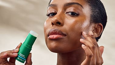 model applying Skin Food Repairing Serum Stick