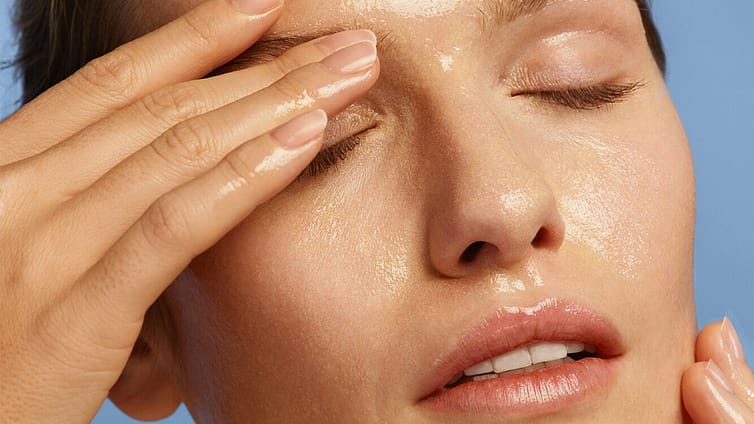 model applying makeup removing cleansing oil