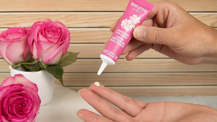 dabbing pearl of weleda smoothing eye cream onto ring finger