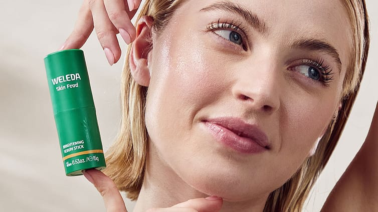 model applying Skin Food Brightening Serum Stick