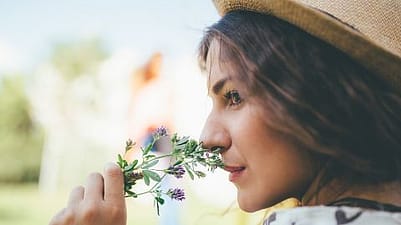 Girl smelling flowers