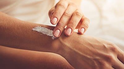 hand applying cream to arm