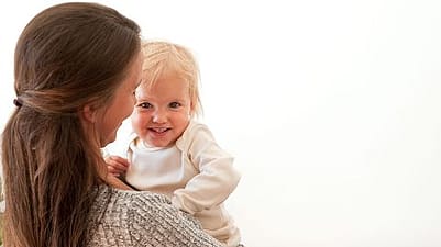 baby on mothers arm