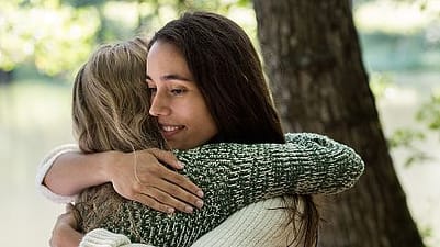 Women hugging.