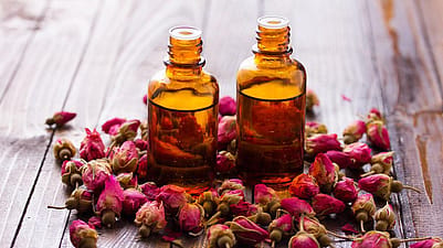 Essential oil bottles and rosebuds