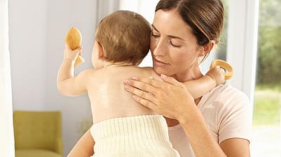 Mother holding baby.