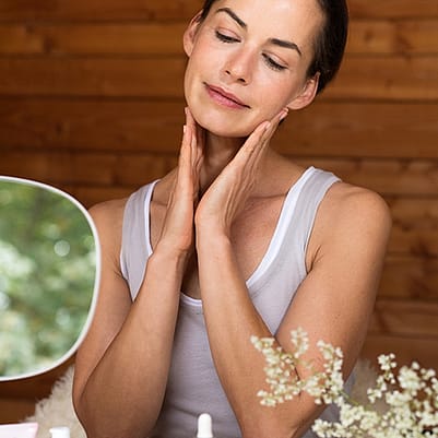 mujer haciéndose un masaje facial