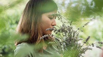 woman standing in a grassy forest