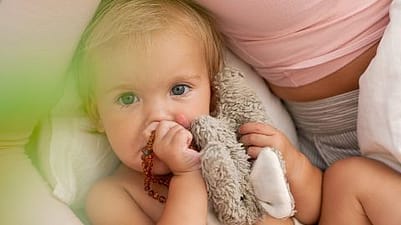 baby holding stuffed toy.