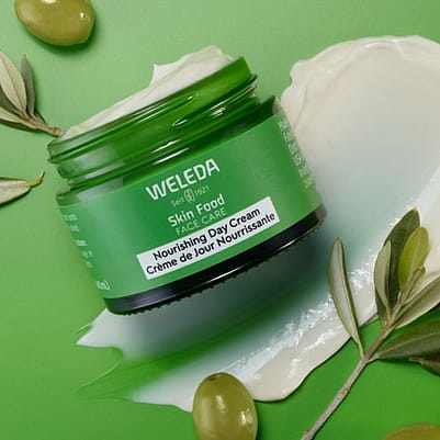 Skinfood day cream with olives on green background