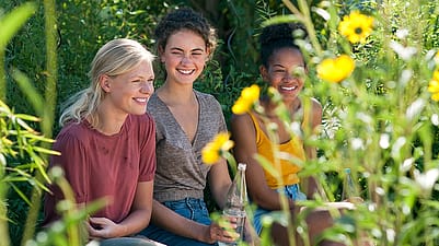 Three teen girls in a garden
