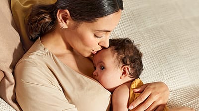 mother kissing baby