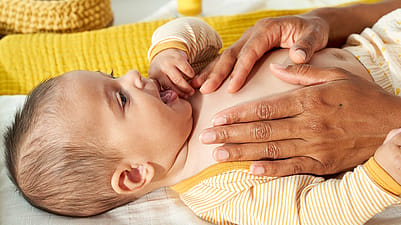 mother gently touching babys body