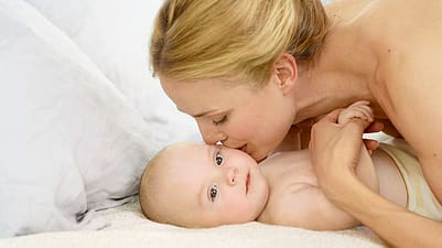 mother kissing babys face
