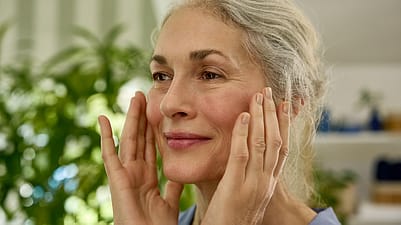 older woman applying cream
