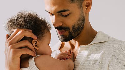father holding babys head