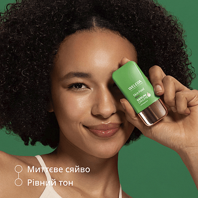 Model holds product in front of her face