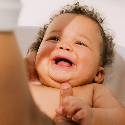 Smiling baby in bath
