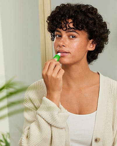 Woman applying lip balm