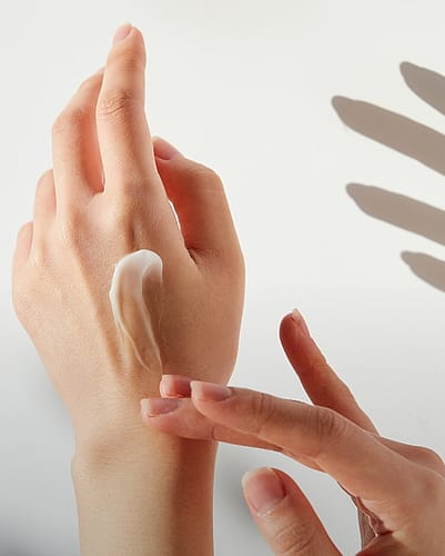 Hands applying hand creme