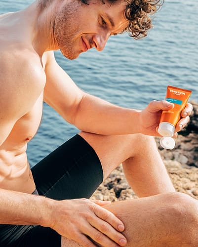Man applying sports product to leg