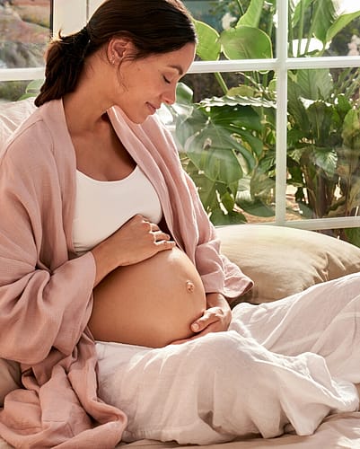 Pregnant mother on a bed