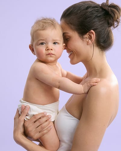 Mother smiling holding baby